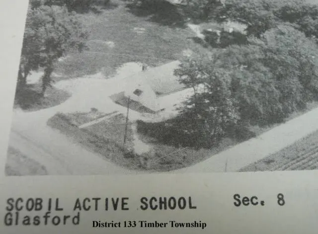 This garage was the original second story of Scovil School. The former school is now a residence. September 2009